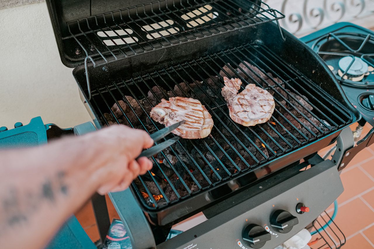 Close-up of two steaks grilled on a barbecue in Sardegna, Italy.